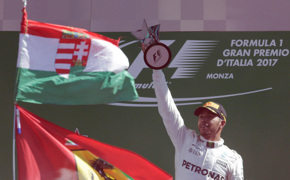 Formula One – F1 – Italian Grand Prix 2017 – Monza, Italy – September 3, 2017 Mercedes’ Lewis Hamilton celebrates winning the race with the trophy on the podium REUTERS/Max Rossi