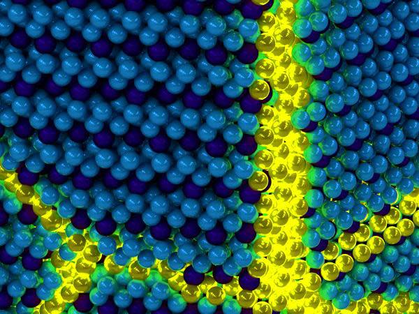 Artist's depiction of the collective excitons of an excitonic solid. The yellow sections signify the 'excitations' in an otherwise ordered solid exciton background: Peter Abbamonte, University of Illinois Department of Physics and Frederick Seitz Materials Research Laboratory