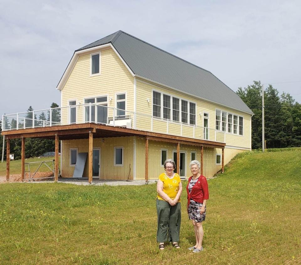 The schoolhouse building currently houses an interpretation space, as well as the Glenaladale Heritage Trust office. Mary Gallant stands next to P.E.I. Lieutenant Governor Antoinette Perry