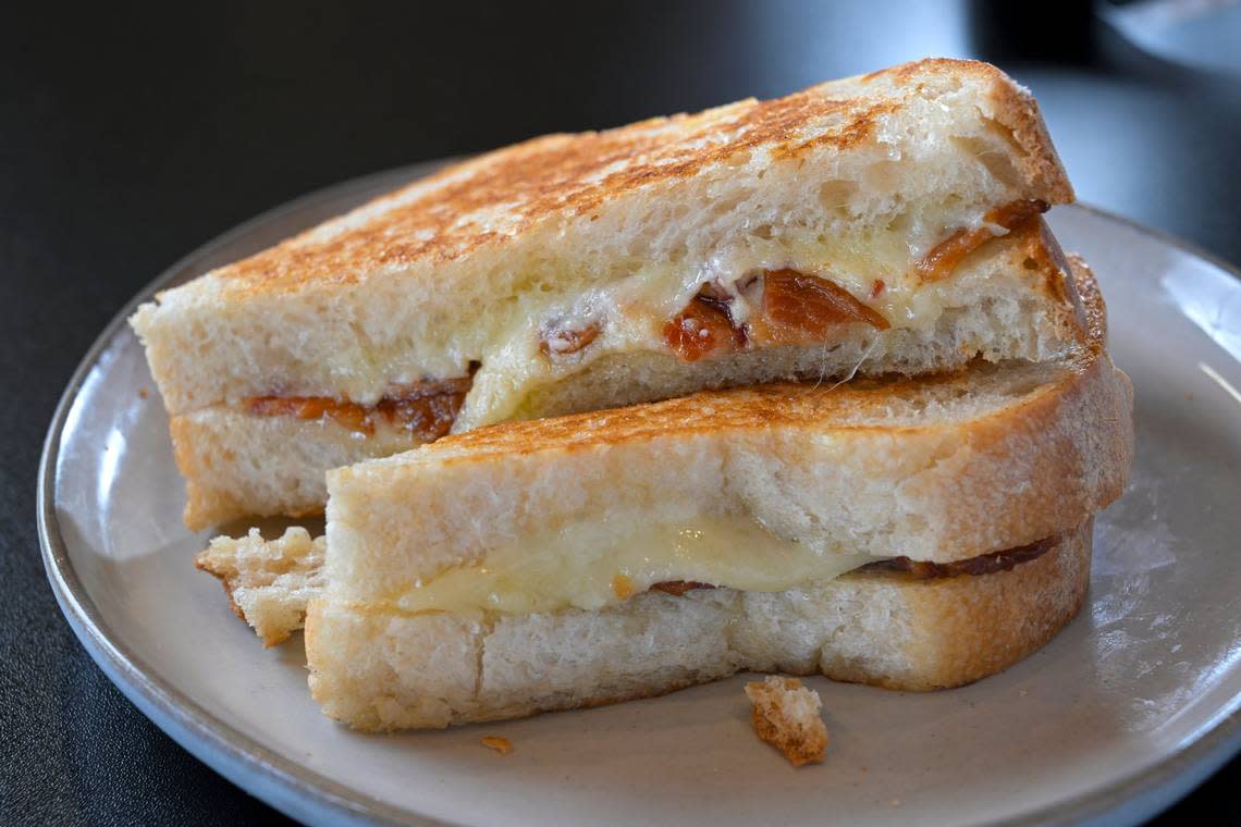 A grilled cheese sandwich topped with Paradise bacon on thick-sliced, homemade sourdough bread at Best Regards Bakery & Cafe, 6759 W. 119th St., Overland Park. The sourdough bread, which is made from scratch, takes three days to make.