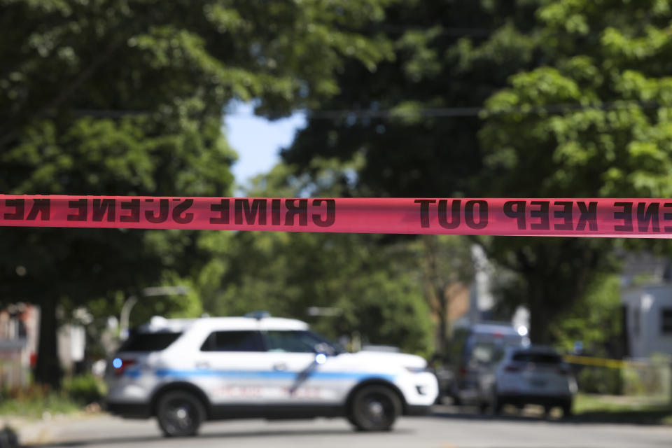 Police tape marks off a Chicago street as officers investigate the scene of a fatal shooting in the city's South Side on Tuesday, June 15, 2021. An argument in a house erupted into gunfire early Tuesday, police said. (AP Photo/Teresa Crawford)