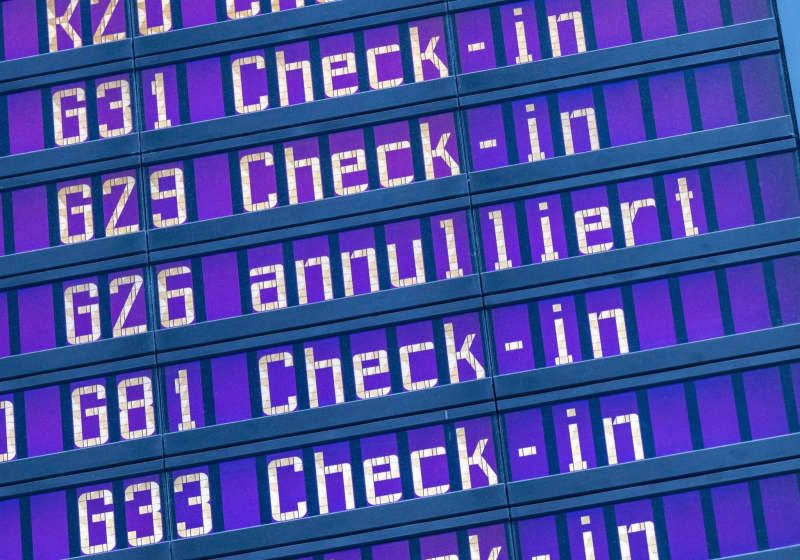 The word "cancelled" can be read on a display board at Munich Airport among several "check in" information. A technical malfunction at German air traffic control previously led to delays and cancellations in German airspace. Peter Kneffel/dpa