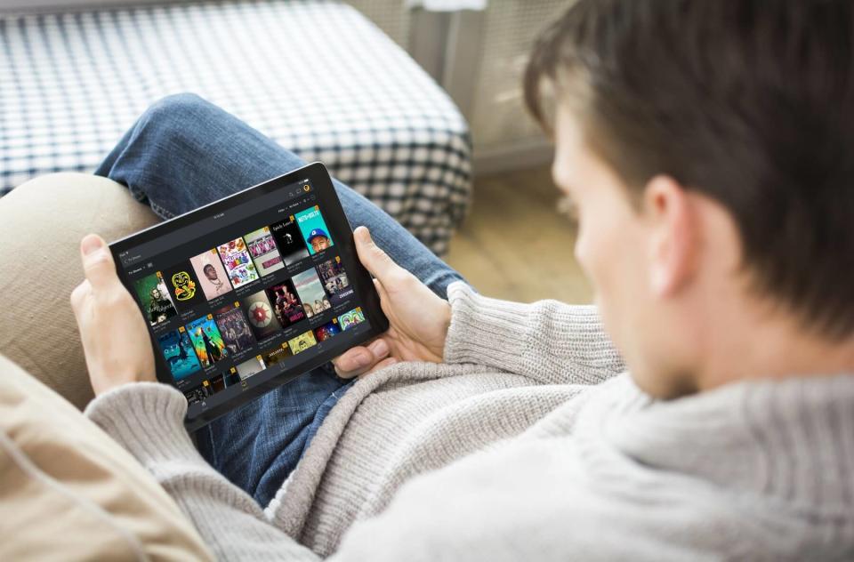 A man browsing Plex on a tablet