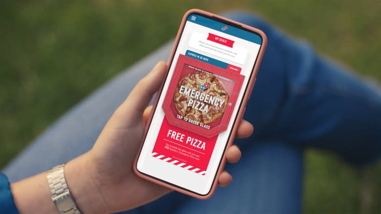 Person mobile-ordering Domino's emergency pizza