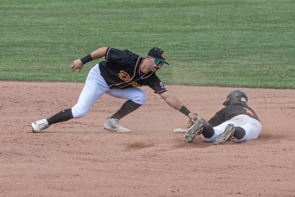 Marc DiLeo from the Buffalo Diesel goes to tag Andy Gayton from the Lombard Orioles during the championship game at C.O. Brown Stadium on Sunday, August 7, 2022.