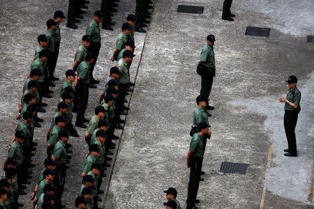 Correctional Services Department officers stand at attention at Lai Chi Kok Reception Centre, where British former banker Rurik Jutting on a double murder trial is held, in Hong Kong, China November 3, 2016. REUTERS/Bobby Yip