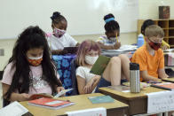 In this photo provided by Charlotte-Mecklenburg Schools, second-grade students at McAlpine Elementary School take part in the classroom learning portion of Camp CMS, Charlotte-Mecklenburg Schools' summer program, in Charlotte, NC, Thursday June 17, 2021. Across the country, school districts were able to greatly expand their summer offerings by leveraging federal pandemic relief funding. (Nancy Pierce/Charlotte-Mecklenburg Schools via AP)