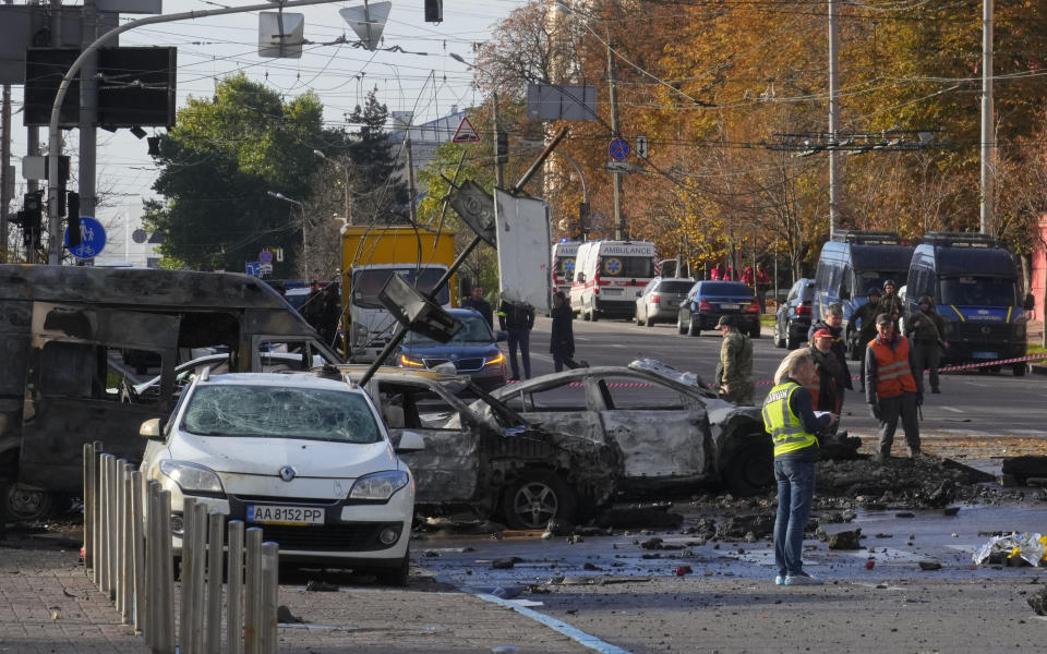 Police inspect the scene of Russian shelling in Kyiv, Ukraine, Monday, Oct. 10, 2022. Two explosions rocked Kyiv early Monday following months of relative calm in the Ukrainian capital. (AP Photo/Efrem Lukatsky)