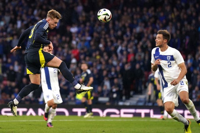 Scotland's Tommy Conway, left, heads at goal against Finland