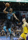 Charlotte Hornets guard Kemba Walker (15) shoots as Los Angeles Lakers guard Lonzo Ball, right, looks on in the first half of an NBA basketball game in Charlotte, N.C., Saturday, Dec. 15, 2018. (AP Photo/Nell Redmond)