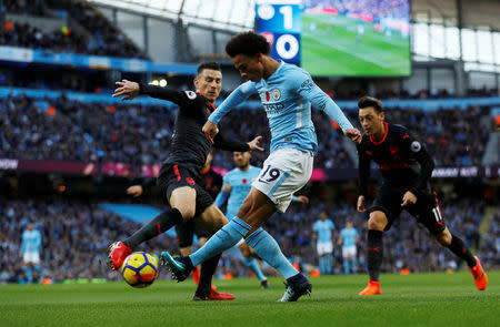 FILE PHOTO - Soccer Football - Premier League - Manchester City vs Arsenal - Etihad Stadium, Manchester, Britain - November 5, 2017. Manchester City's Leroy Sane in action with Arsenal's Laurent Koscielny. Action Images via Reuters/Lee Smith