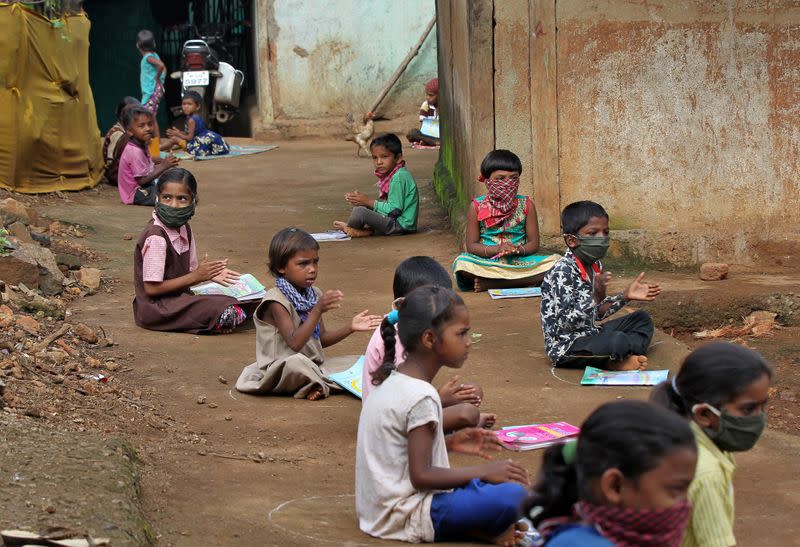 Schoolchildren learn with the help of pre-recorded lessons in Dandwal village, Maharashtra