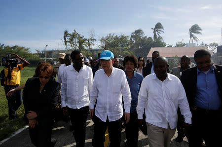 UN Secretary General Ban Ki Moon (C) and Haitian interim Prime Minister Enex Jean-Charles (2nd L) walk in the MINUSTAH base during a visit after Hurricane Matthew in Les Cayes, Haiti, October 15, 2016. REUTERS/Andres Martinez Casares