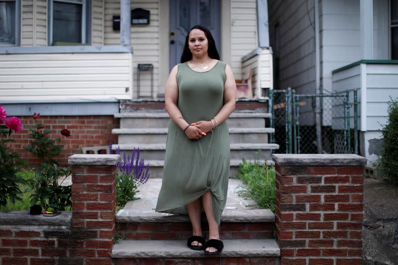 Gabby Niziolek poses for a photograph in front of her home in Elizabeth, New Jersey
