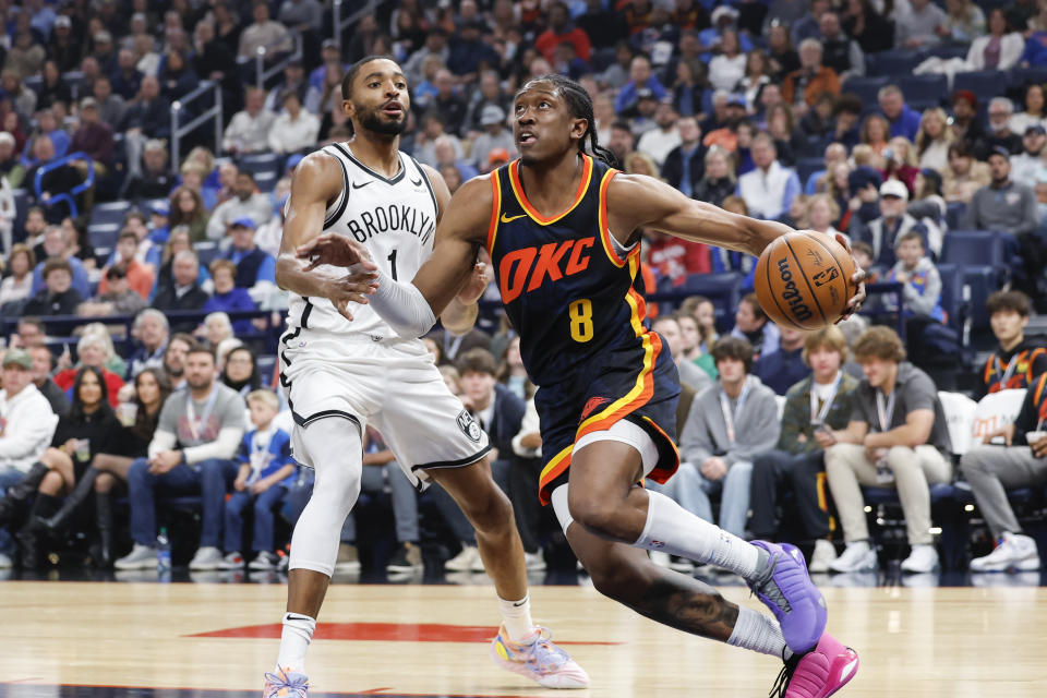 Dec 31, 2023; Oklahoma City, Oklahoma, USA; Oklahoma City Thunder forward Jalen Williams (8) drives to the basket around Brooklyn Nets forward Mikal Bridges (1) during the first quarter at Paycom Center. Mandatory Credit: Alonzo Adams-USA TODAY Sports