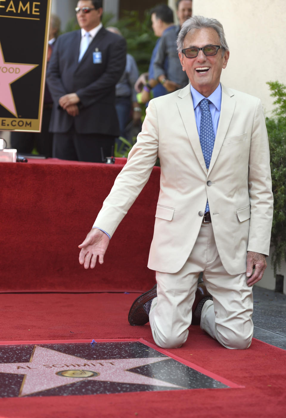 FILE - Recording and mix engineer Al Schmitt poses with his star during the ceremony honoring him with a star on the Hollywood Walk of Fame on Aug. 13, 2015, in Los Angeles. Schmitt, one of the world's most honored musical producers and engineers has died. The Grammy winner, who worked with everyone from Sam Cooke to Steely Dan to Frank Sinatra, was 91. (Photo by Chris Pizzello/Invision/AP, File)