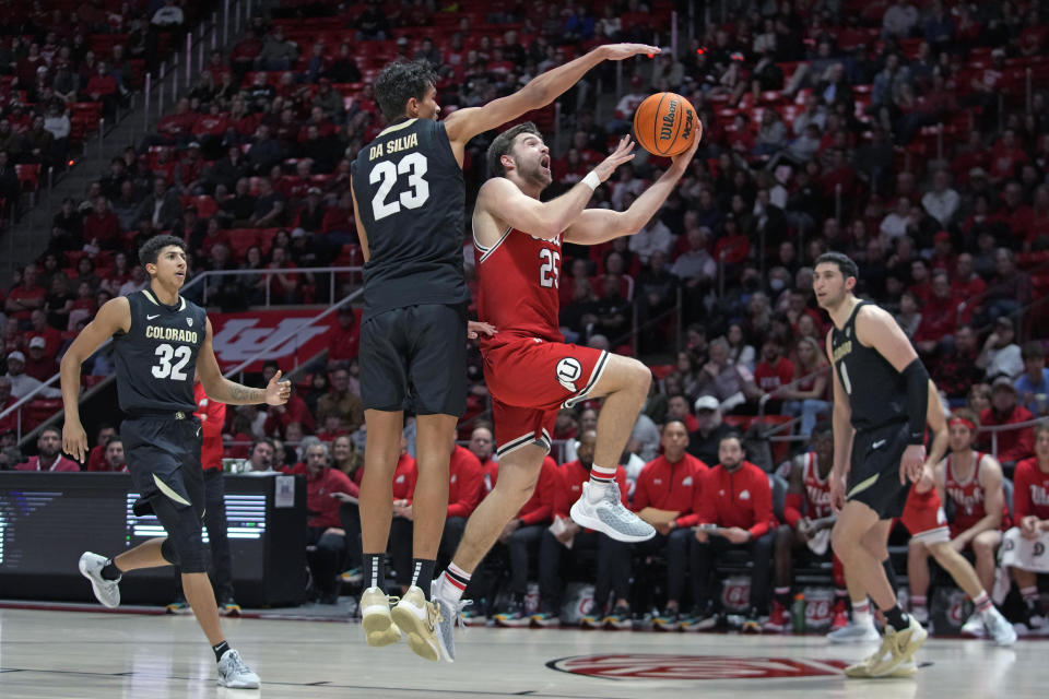 Utah guard Rollie Worster (25) goes to the basket as Colorado forward Tristan da Silva (23) defends during the second half of an NCAA college basketball game Saturday, Feb. 11, 2023, in Salt Lake City. (AP Photo/Rick Bowmer)