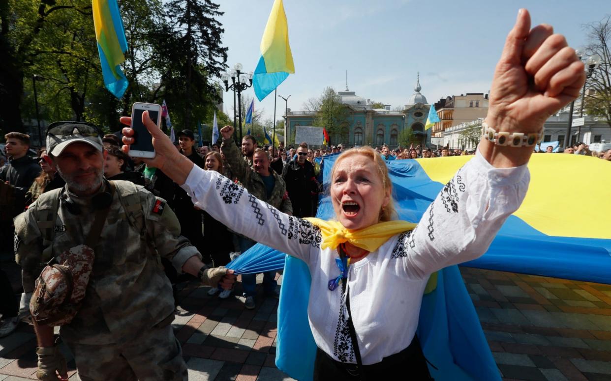 Supporters of the language law rally outside parliament on Thursday - REX