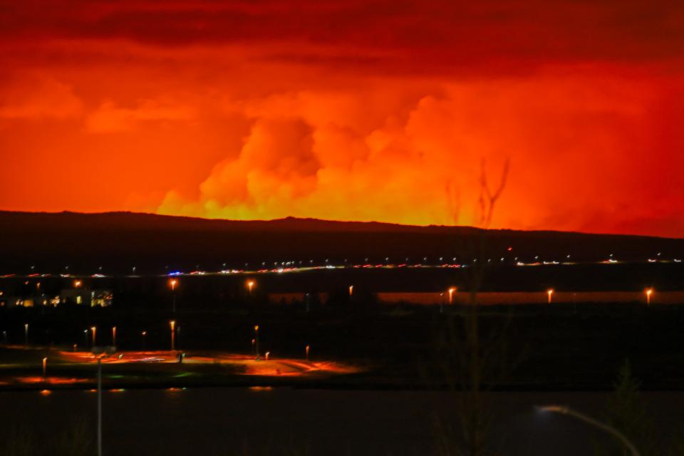 The sky is coloured orange as molten lava flows out from a fissure on the Reykjanes peninsula north of the evacuated town of Grindavik, western Iceland on March 16, 2024. Lava spewed Saturday from a new volcanic fissure on Iceland's Reykjanes peninsula, the fourth eruption to hit the area since December, authorities said.