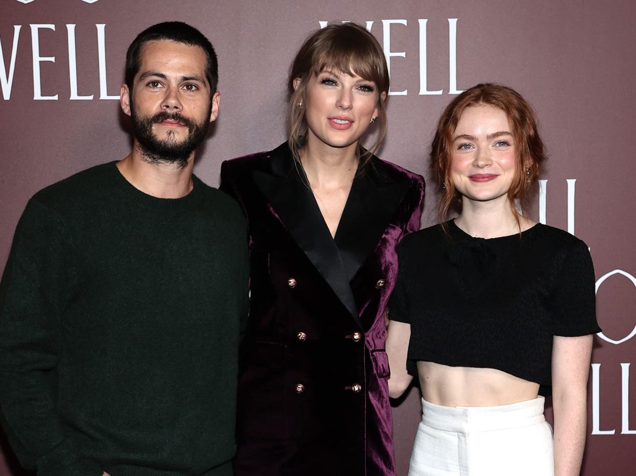 Dylan O'Brien, Taylor Swift, and Sadie Sink smile on the "All Too Well" red carpet.