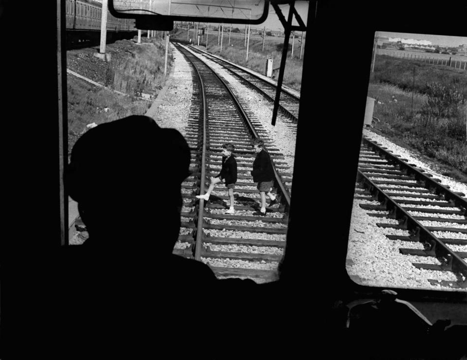 kids crossing a train track