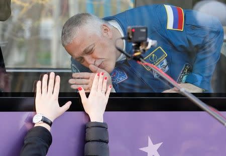 The International Space Station (ISS) crew member Fyodor Yurchikhin of Russia wave from a bus before leaving for pre-flight preparation at the Baikonur cosmodrome, Kazakhstan, April 20, 2017. REUTERS/Shamil Zhumatov