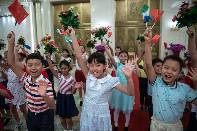 Chinese children with Chinese and Sierra Leone flags prepare for the welcome ceremony for the Sierra Leone President Julius Maada Bio. Africa's resources have helped fuel China's transformation into the world's second largest economy