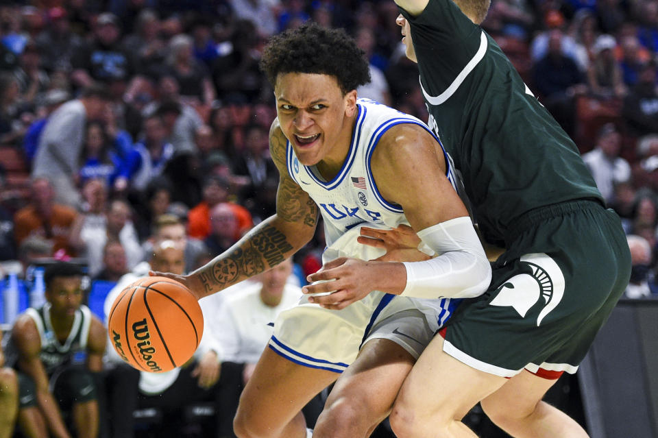 Mar 20, 2022; Greenville, SC, USA; Duke Blue Devils forward Paolo Banchero (5) carries the ball against Michigan State Spartans forward Joey Hauser (10) in the first half during the second round of the 2022 NCAA Tournament at Bon Secours Wellness Arena. Mandatory Credit: Bob Donnan-USA TODAY Sports