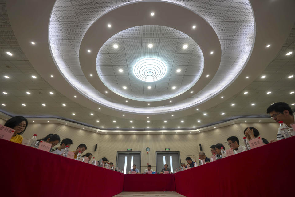 Journalists and scientists attend a news conference to discuss the contributions of Chinese scientists using the Five-hundred-meter Aperture Spherical Telescope (FAST) in southern China to an international collaboration on gravitational waves at the National Astronomical Observatories of the Chinese Academy of Sciences (NAOC) in Beijing, Tuesday, June 27, 2023. On Wednesday, June 28, 2023, researchers reported signals from what they call low-frequency gravitational waves — changes in the fabric of the universe that are created by huge objects moving around and colliding in space. It took decades of work by scientists across the globe to track down the evidence for these super-slow wobbles. (AP Photo/Mark Schiefelbein)