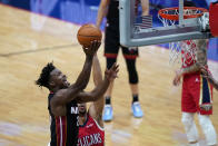 Miami Heat forward Jimmy Butler (22) goes to the basket next to New Orleans Pelicans guard Josh Hart during the first half of an NBA basketball game in New Orleans, Thursday, March 4, 2021. (AP Photo/Gerald Herbert)