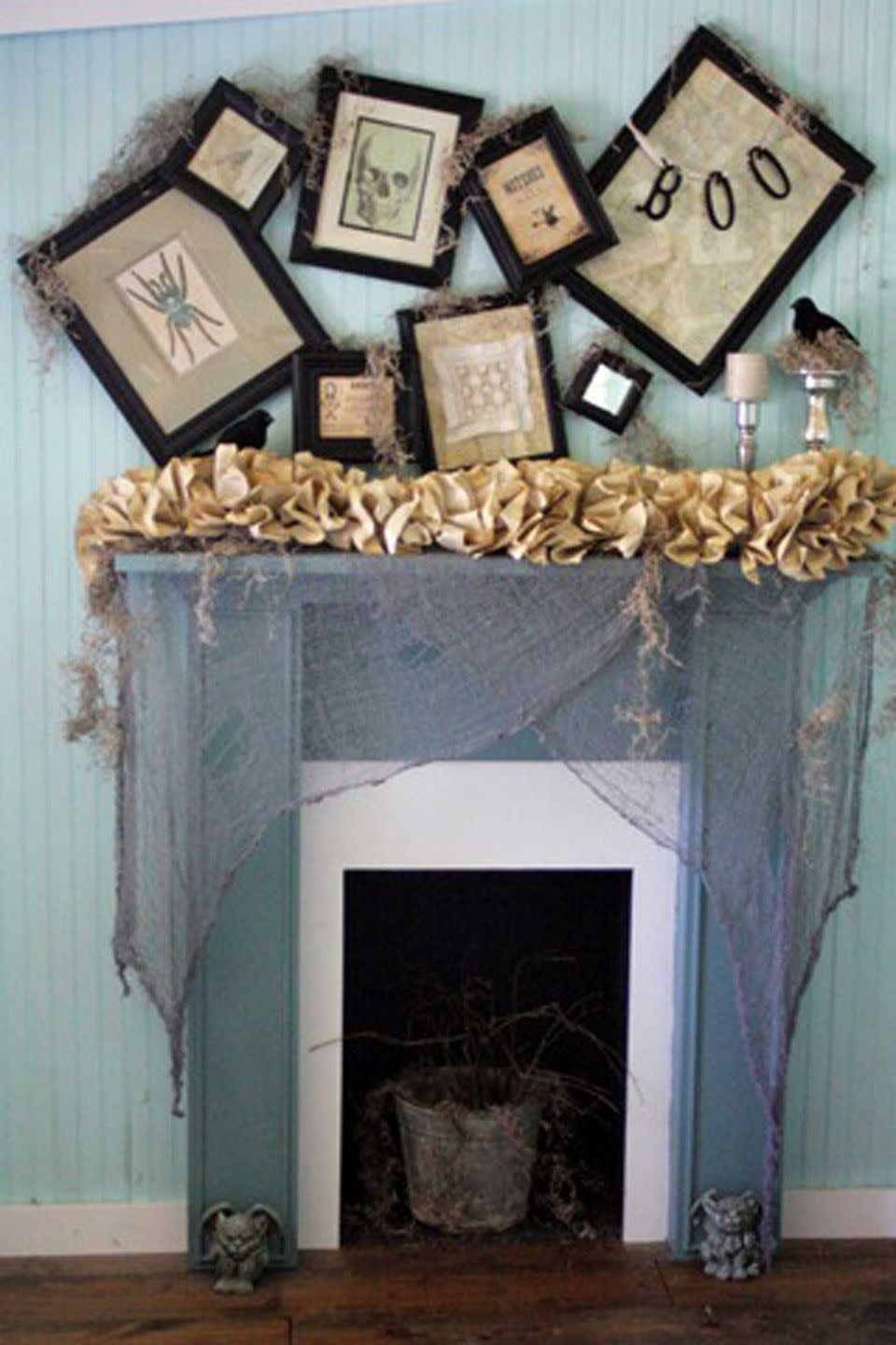 <p>Gina Luker of The Shabby Creek Cottage made this budget-friendly look using dollar store finds, old book pages (see her DIY dictionary print candles), and an arrangement of lopsided picture frames. <br></p><p><strong>See more at <a href="http://www.theshabbycreekcottage.com/2011/10/day-7-halloween-mantle-mantel.html" rel="nofollow noopener" target="_blank" data-ylk="slk:The Shabby Creek Cottage;elm:context_link;itc:0;sec:content-canvas" class="link ">The Shabby Creek Cottage</a>.</strong> </p>