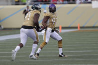 NFC defensive end Fletcher Cox, of the Philadelphia Eagles, runs for a touchdown, after an interception by strong safety Harrison Smith, of the Minnesota Vikings, (22), during the second half of the NFL Pro Bowl football game against the AFC, Sunday, Jan. 26, 2020, in Orlando, Fla. To the right is defensive end Everson Griffen, of the Minnesota Vikings (97). (AP Photo/John Raoux)