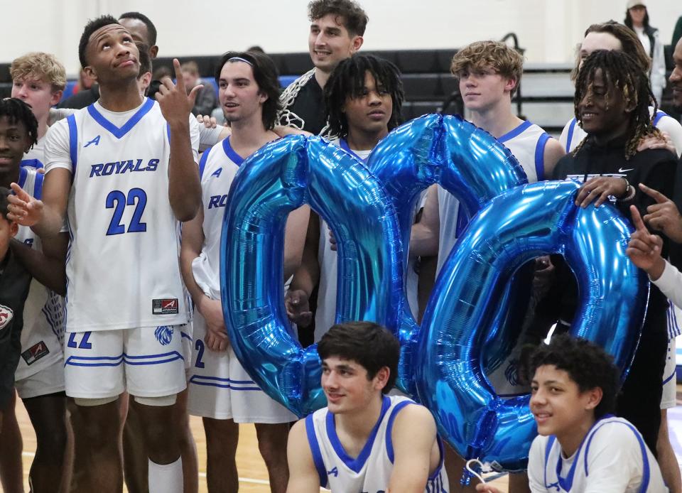 CVCA's Darryn Peterson hold up his index finger as he looks up to ceiling at the No. 1 balloon as he poses for photos to celebrate his 1,000th point after a win over Northwest, Tuesday, Feb. 14, 2023.