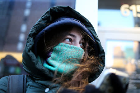 A woman bundles up against the cold temperature as she walks in Manhattan in New York City, New York, U.S., January 5, 2018. REUTERS/Amr Alfiky