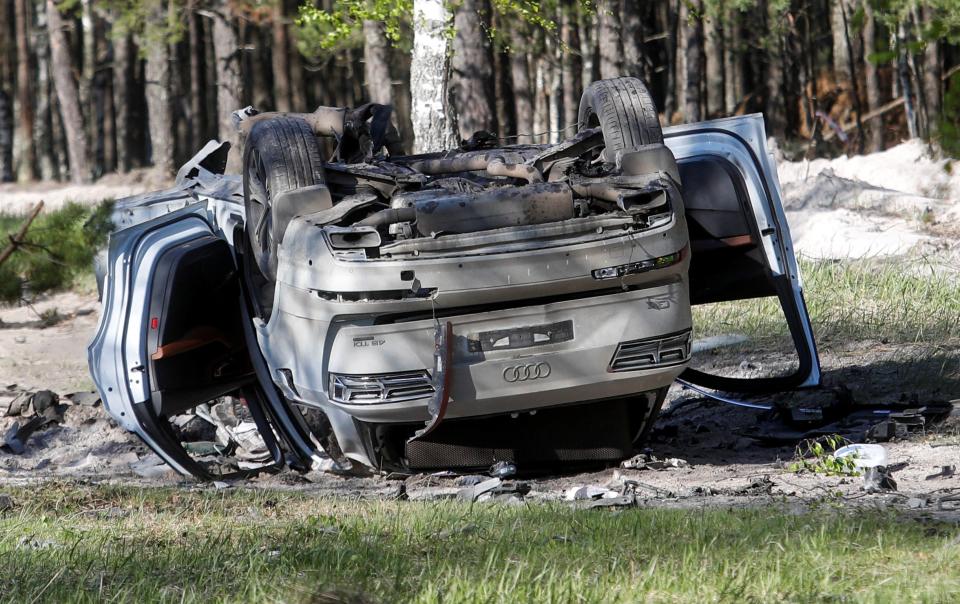 A view shows a damaged white Audi Q7 car lying overturned on a track next to a wood, after Russian nationalist writer Zakhar Prilepin was allegedly wounded in a bomb attack in a village in the Nizhny Novgorod region (REUTERS)