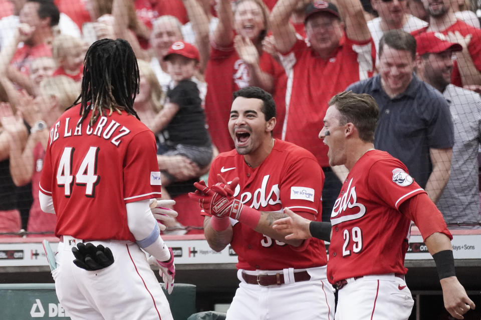 Cincinnati Reds' Christian Encarnacion-Strand, center, and TJ Friedl, right, celebrate with Elly De La Cruz after he scored against the Toronto Blue Jays during the fourth inning of a baseball game Saturday, Aug. 19, 2023, in Cincinnati. (AP Photo/Joshua A. Bickel)