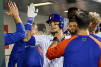 New York Mets' Javier Baez celebrates with teammates after hitting a two-run home run in the sixth inning of the baseball game against the Cincinnati Reds, Saturday, July 31, 2021, in New York. (AP Photo/Mary Altaffer)