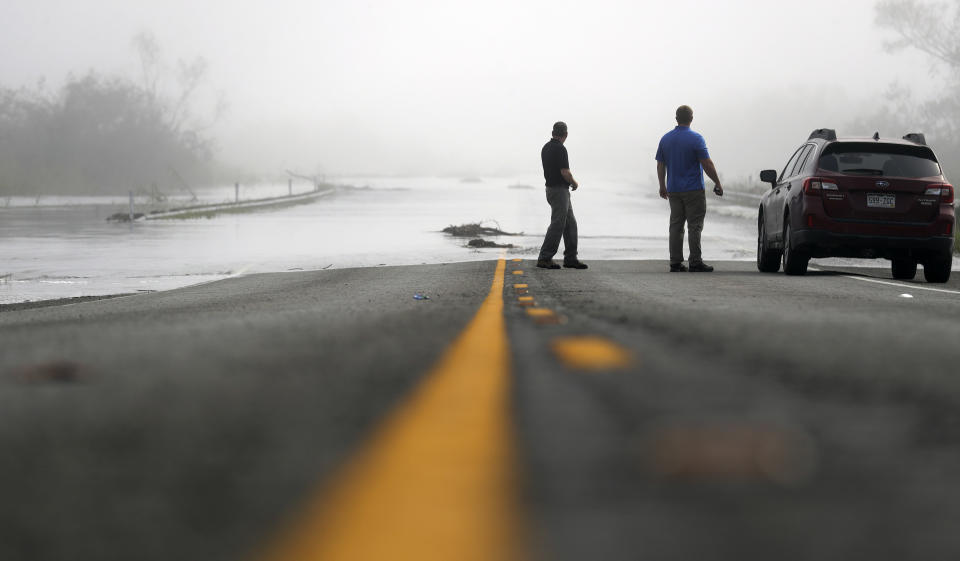 <p>Motorists watch as flood waters from the Guadalupe River spill over Texas Highway 35, Friday, Sept. 1, 2017, in Tivoli, Texas, north of Rockport. (Photo: Eric Gay/AP) </p>