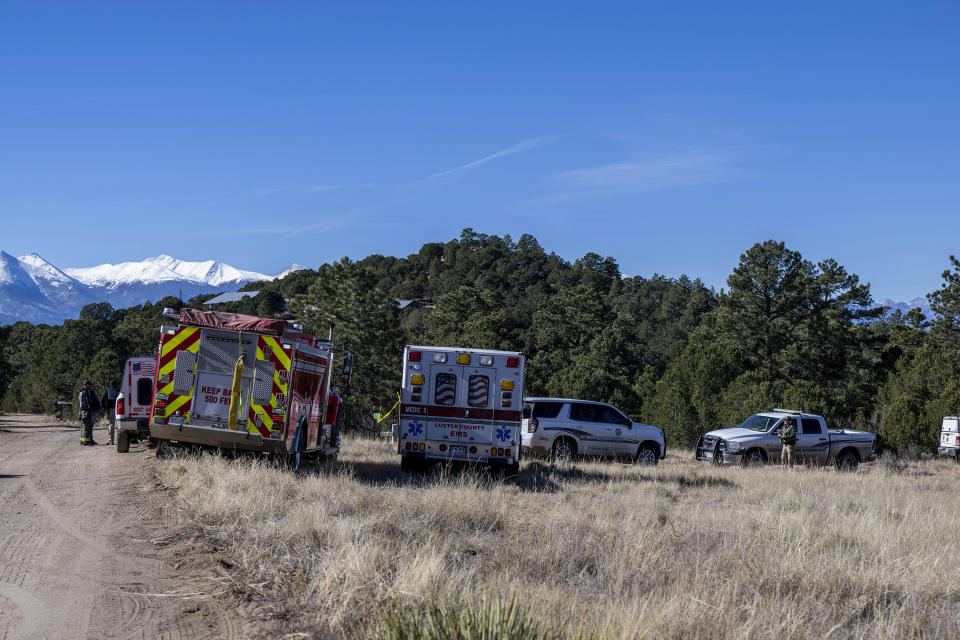 First-responder vehicles remained Tuesday, Nov. 21, 2023, at the site of a fatal shooting near Westcliffe, Colo. A man was on the run Tuesday after police say he fatally shot three people and critically wounded a fourth over a years-long property dispute over the use of an easement on the suspect's property in rural Colorado, authorities said. (Parker Seibold/The Gazette via AP)