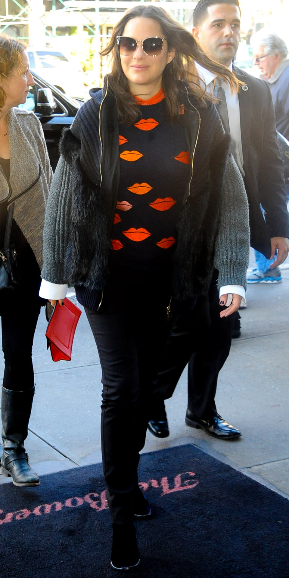 The actress glowed in a lip-print sweater, black Seraphine trousers, a furry gray sweater, and Linda Farrow sunnies while hitting the city streets.