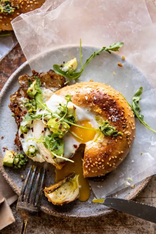 <p>Half Baked Harvest</p><p>Crispy parmesan cheese, basil pesto, seeded bagels and perfectly cooked sunny-side-up eggs. Serve yours up with avocado and herbs and you’ll have a great breakfast to enjoy any day of the week.</p><p><strong>Get the recipe: </strong><strong><a href="https://www.halfbakedharvest.com/crispy-parmesan-and-pesto-egg-in-a-bagel/" rel="nofollow noopener" target="_blank" data-ylk="slk:Crispy Parmesan and Pesto Egg in a Bagel;elm:context_link;itc:0;sec:content-canvas" class="link ">Crispy Parmesan and Pesto Egg in a Bagel</a></strong></p>