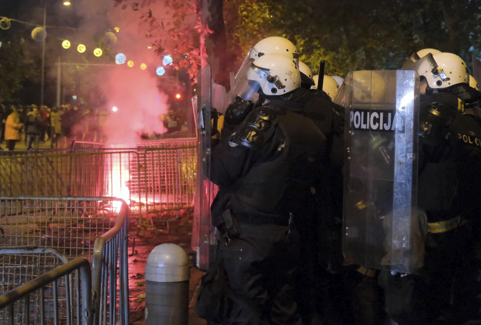 Montenegro riot police guard the parliament building during clashes in Podgorica, Montenegro, Monday, Dec. 12, 2022. Clashes erupted on Monday during an opposition protest in Montenegro reflecting a deep political crisis between the pro-Western and pro-Serb and pro-Russian camps in the small Balkan country that is a member of NATO. (AP Photo/Risto Bozovic)