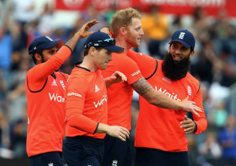 England's Adil Rashid (L), Eoin Morgan (2nd L) and Moeen Ali (R) congratulate Ben Stokes (2nd R) during his three-wicket, last over during the T20 International match against Australia in Cardiff on August 31, 2015