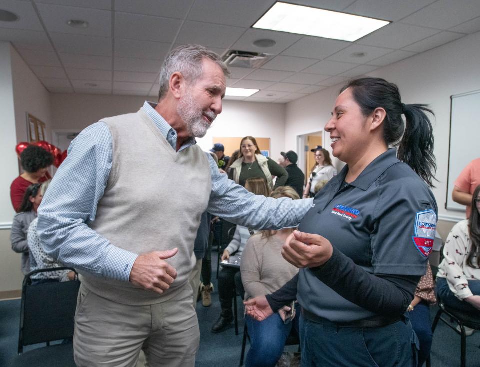 Richard McCool, 67, left, thanks EMT Sandra Soto
during a gathering at the Lifeguard Ambulance Station in Milton on Friday, Feb. 3, 2023.  First responders along with a personal trainer, and gym attendees helped save McCool’s life when he suffered cardiac arrest while working out at a Milton gym in Dec. 2022.