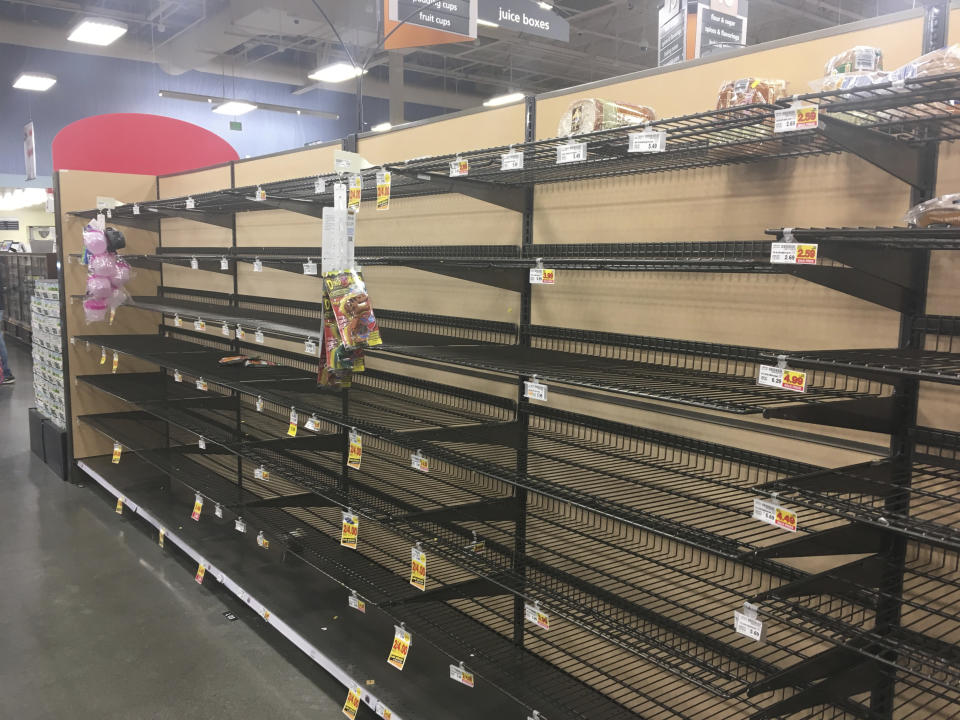 Empty shelves where bread is normally located are shown at a grocery store in Anchorage, Alaska, on Sunday, Dec. 2, 2018, two days after a magnitude 7.0 earthquake was centered about 7 miles north of the city. Anchorage officials urged residents not to stock up and hoard supplies because the supply chain of goods was not interrupted. (AP Photo/Mark Thiessen)