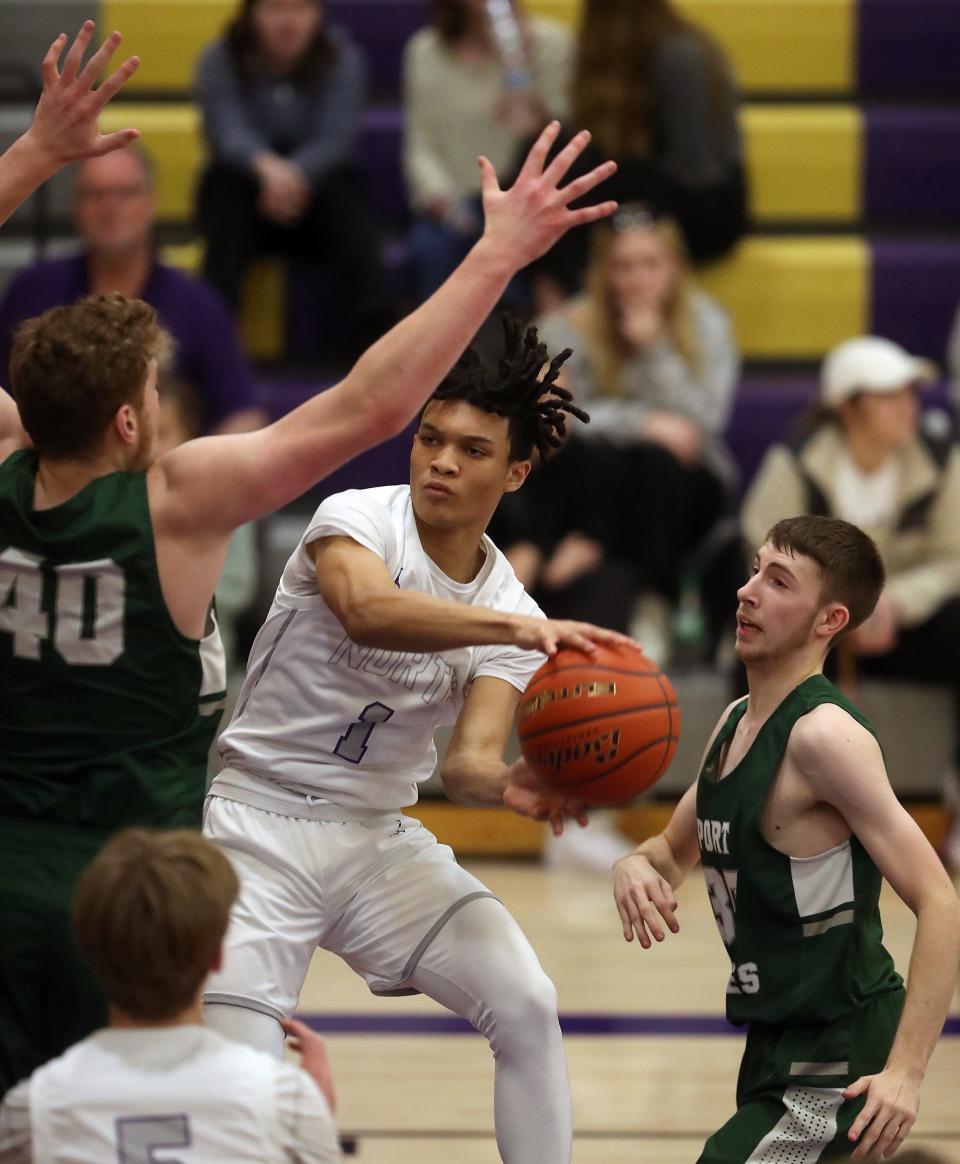 North Kitsap's Jalen East (1) looks to pass the ball while under the pressure of Port Angeles's Isaiah Shamp (40) during the second half of their game in Poulsbo on Tuesday, Jan 3, 2023.