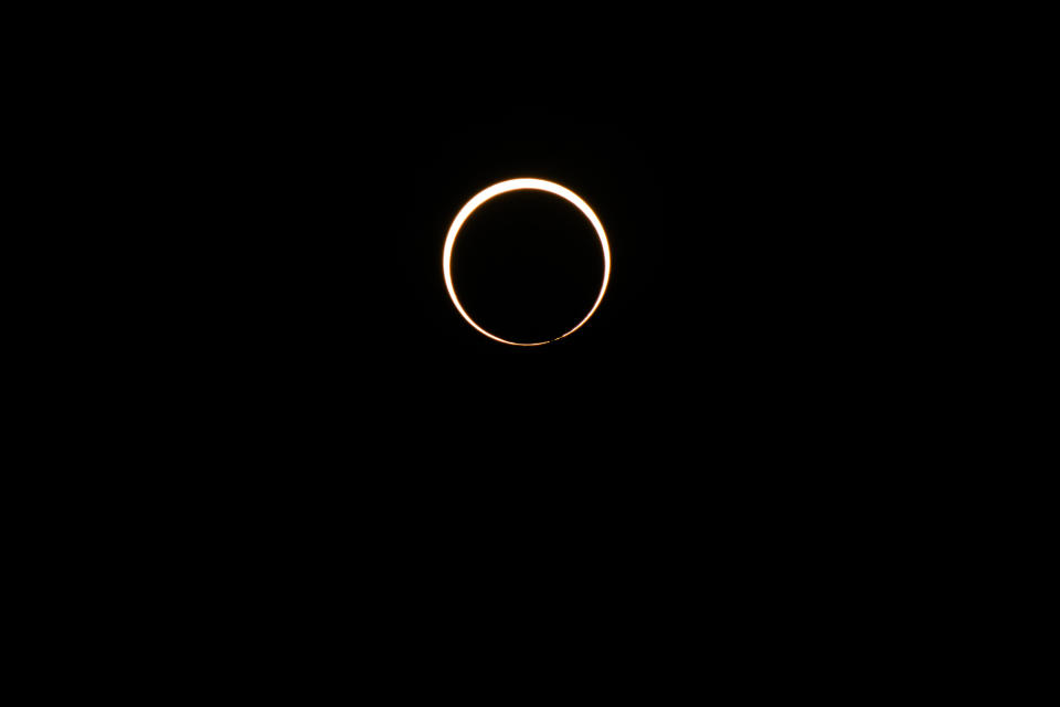  The moon begins its descent below the sun's horizon during an annular solar eclipse on October 14, 2023 in Kerrville, Texas. / Credit: BRANDON BELL / Getty Images