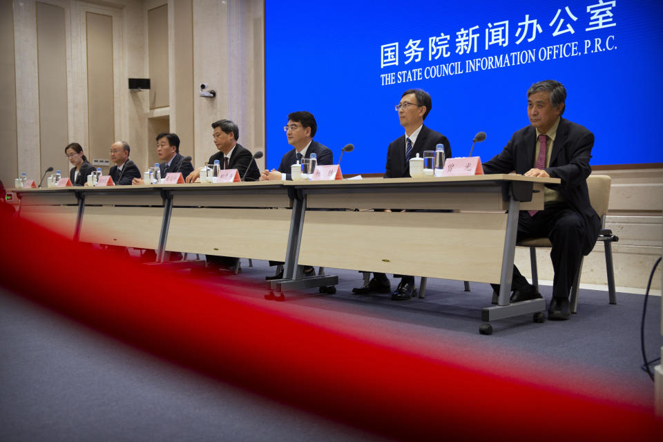 Chinese health officials attend a press conference held to discuss COVID-19 vaccine-related issues at the State Council Information Office in Beijing, Friday, Sept. 25, 2020. A Chinese health official said Friday that the country's annual production capacity for COVID-19 vaccines will top 1-billion next year, following an aggressive government support program for new factories. (AP Photo/Mark Schiefelbein)