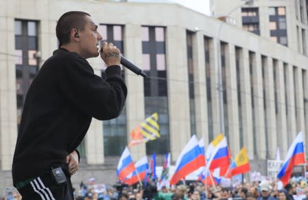 Russian rapper Face performs during a rally to demand authorities allow opposition candidates to run in a local election in Moscow