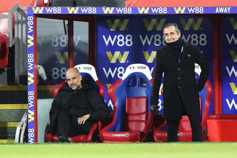 Pep Guardiola takes a seat in the dugout (Getty)